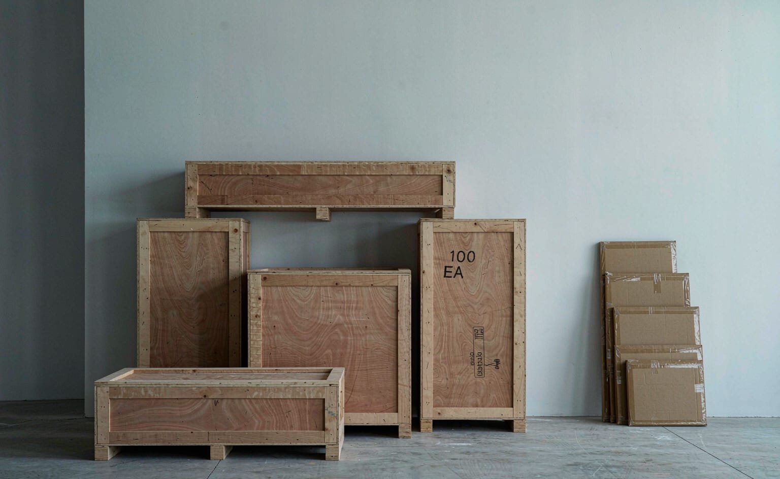 Export crates and flat-packed cartons staged for container loading