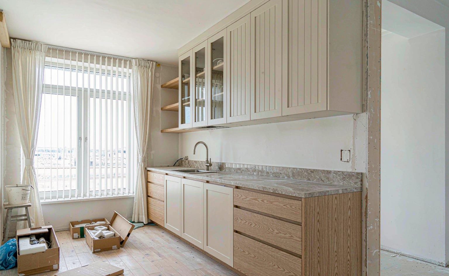Kitchen cabinetry being installed on site